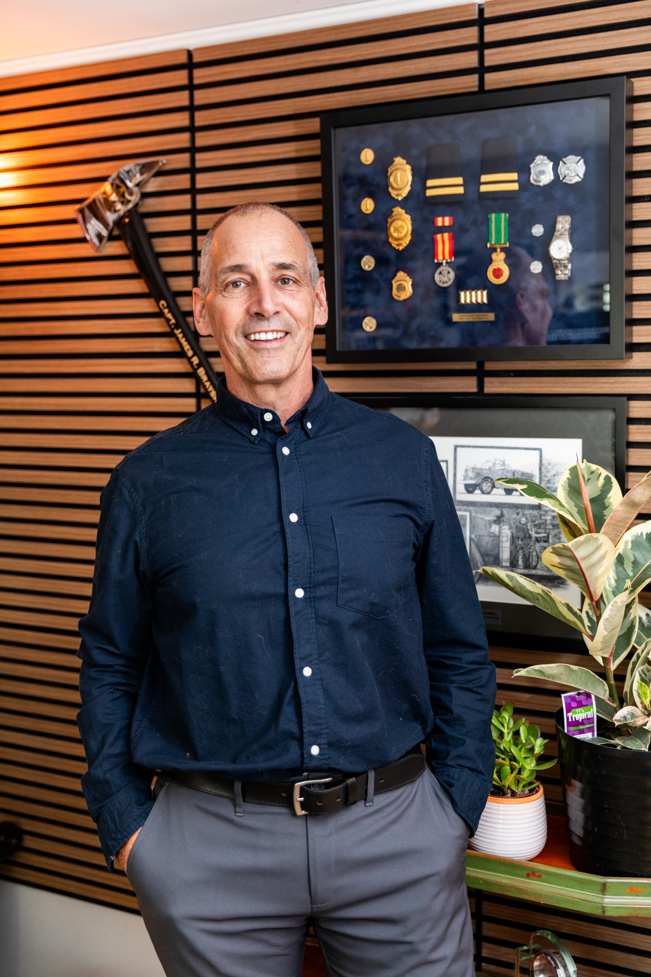 Jim Brayshaw beside military medals display